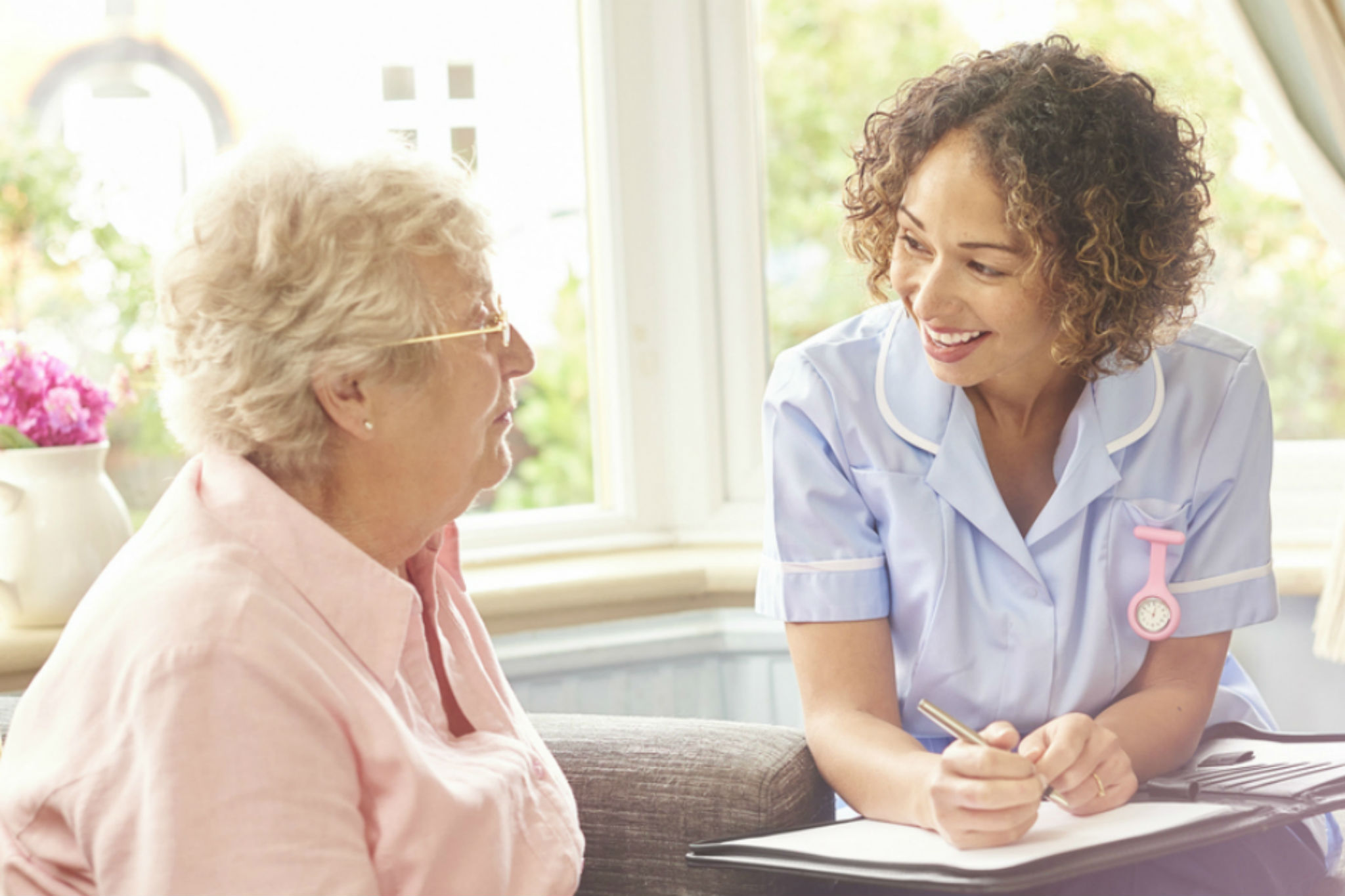Healthcare professional talking to a care home resident
