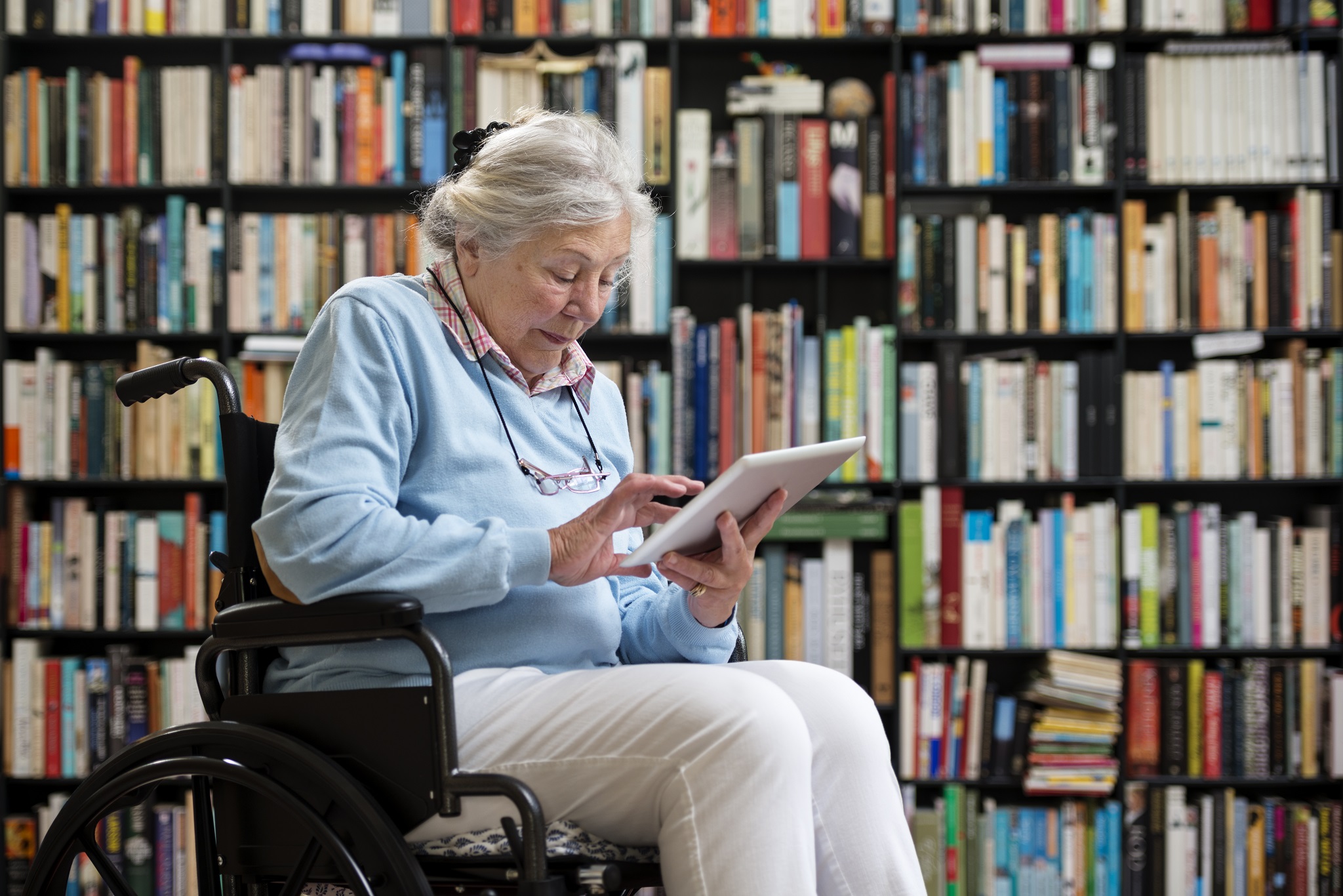 Older lady in wheelchair in a library