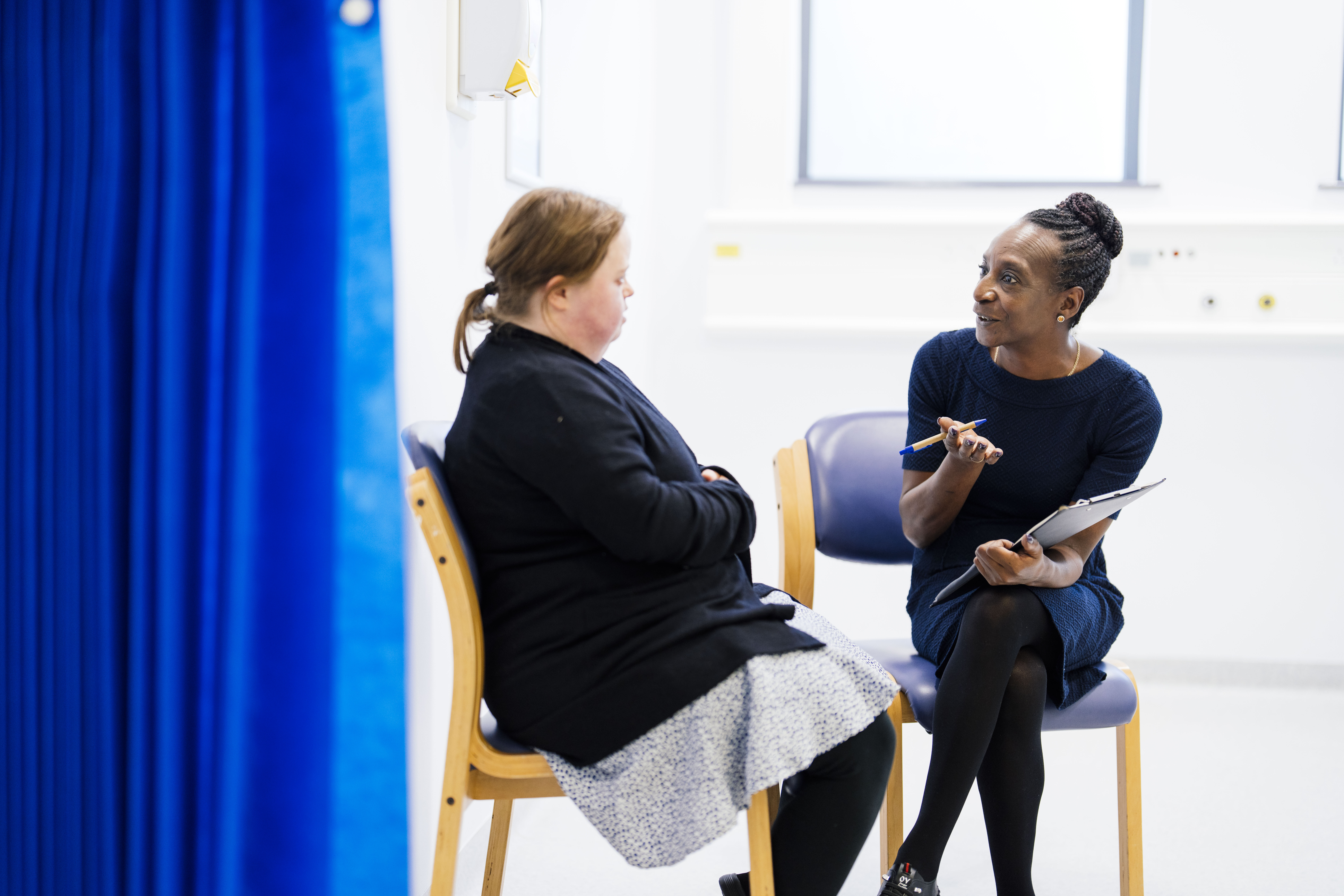 Female patient talking to healthcare professional