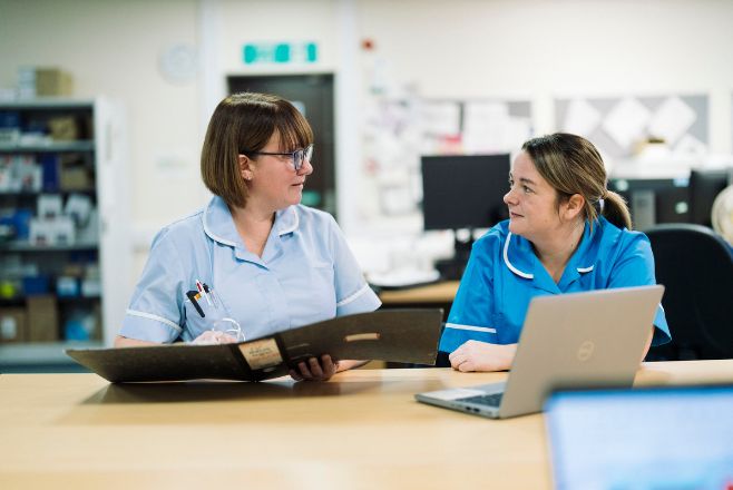 Two nurses talking to one another